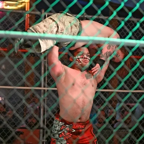 warrior picks up dwarf wrestler