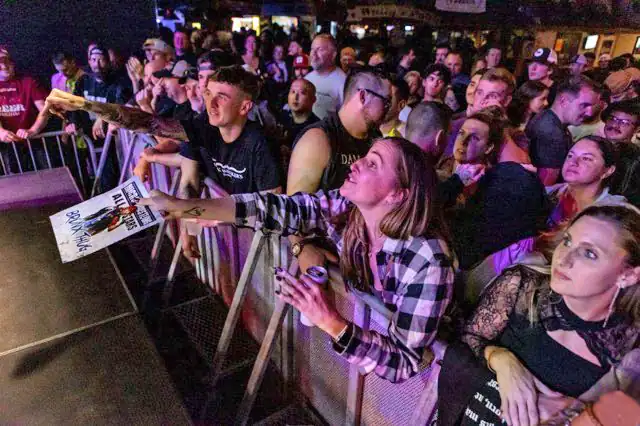crowd asking midget wrestler for autograph
